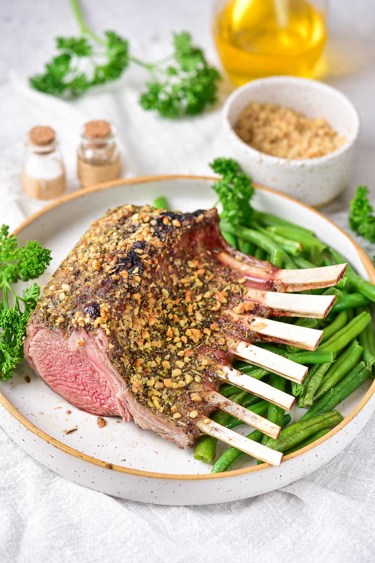the finished air fryer rack of lamb on a serving plate