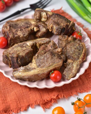 A plate of cooked lamb chops ready to serve