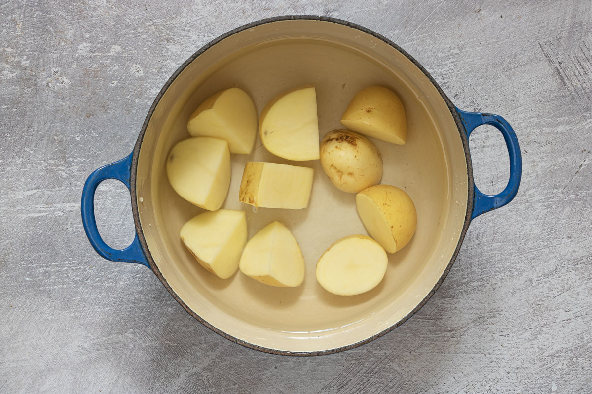 top down view of cubed potatoes inside a cooking pot to use for the how long to boil potatoes for potato salad recipe