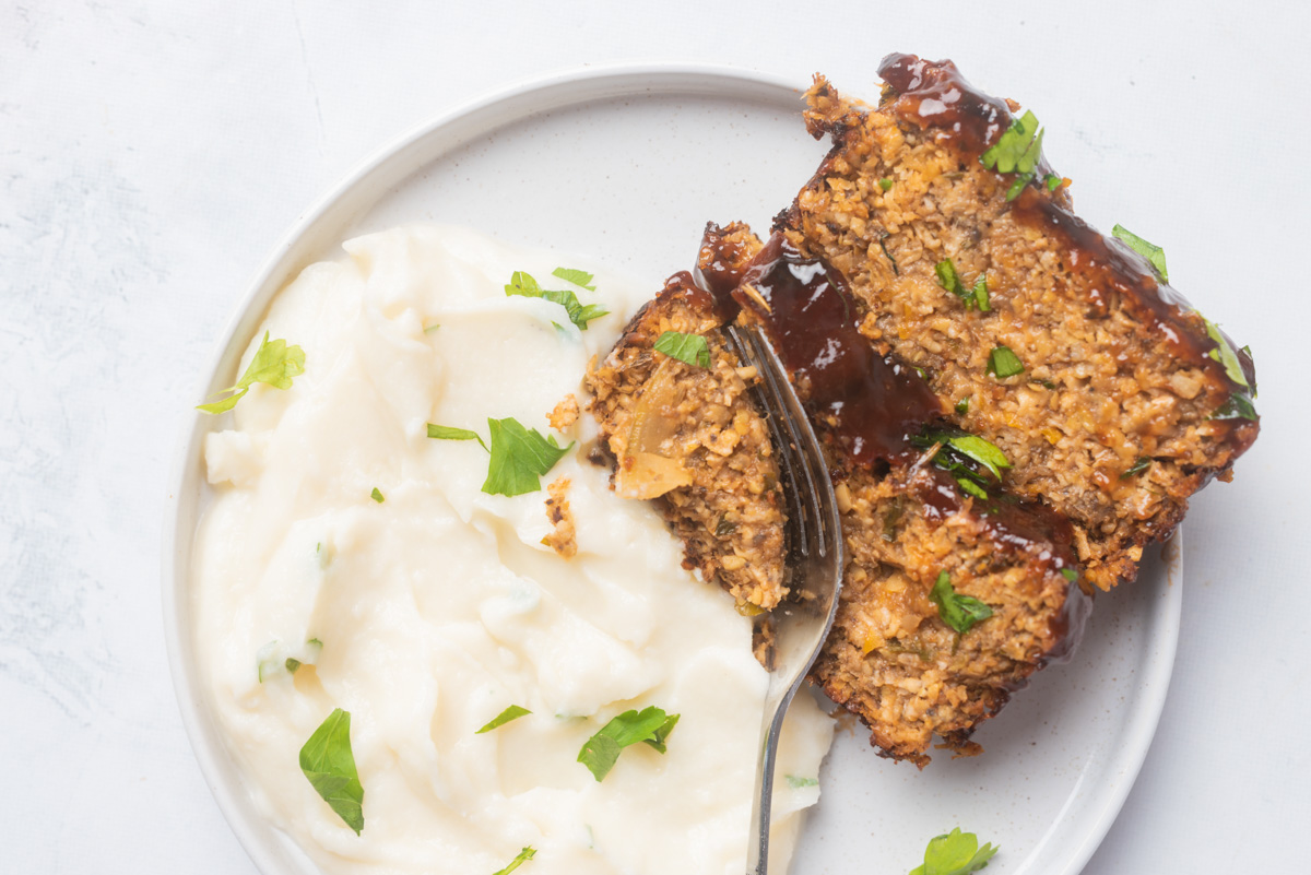a plate of vegan meatloaf and mashed potatoes