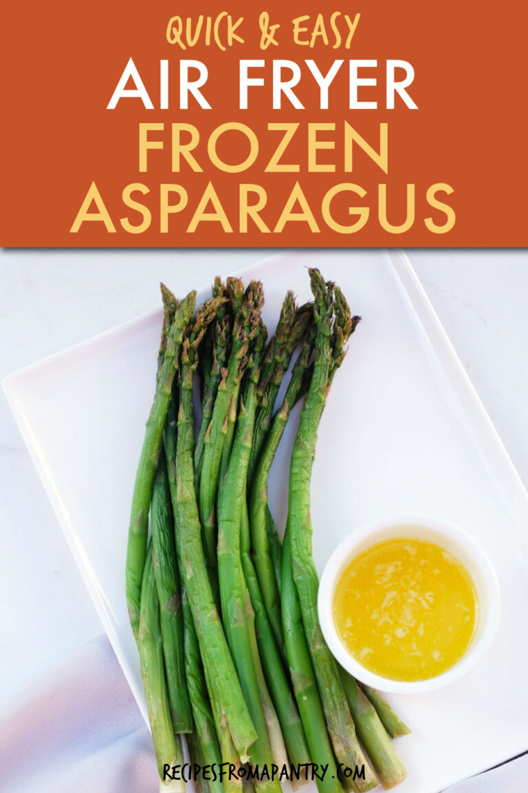 Cooked asparagus on a square plate with a side dish of melted butter