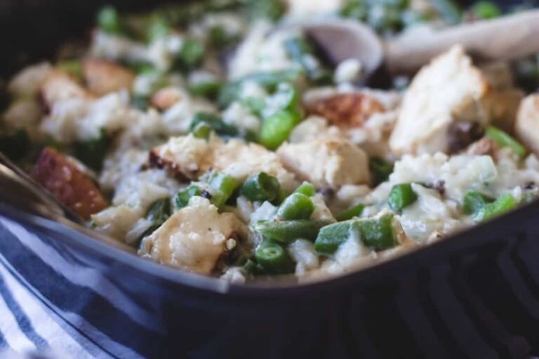 Green bean and chicken casserole in a black casserole dish.