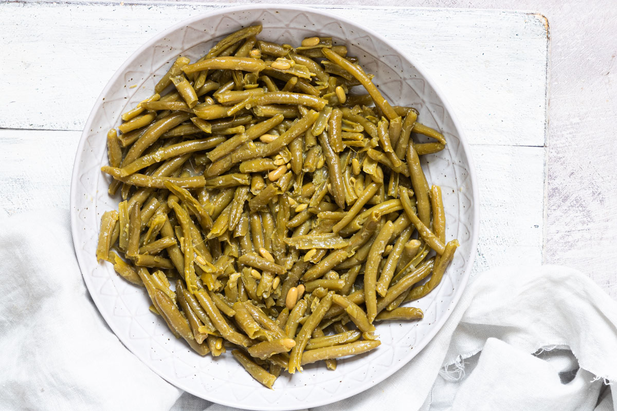 a white plate filled with the cooked canned green beans