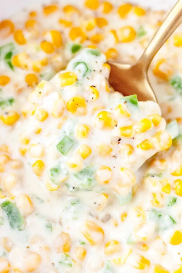 Jalapeno Cream Corn with a gold serving spoon in it.