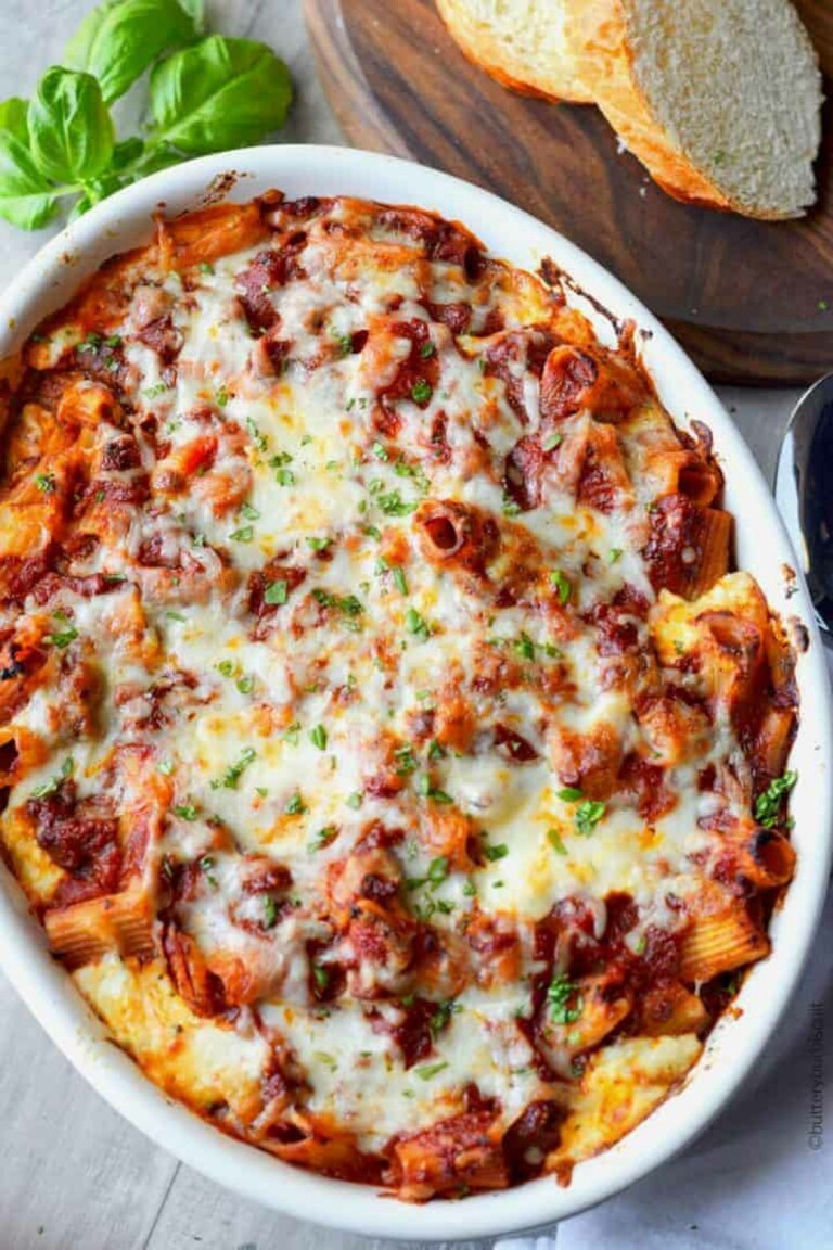 Spicy Italian Sausage Baked Ziti in a white casserole dish