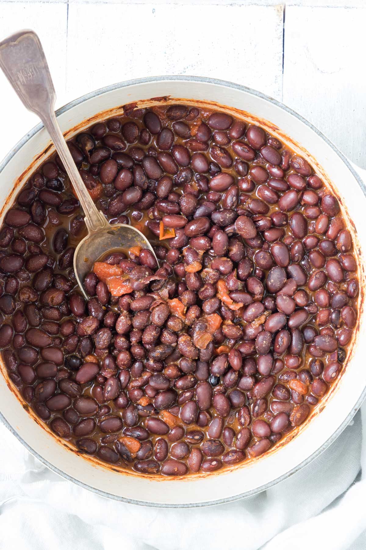 a bowl of the cook canned black beans recipe with a serving spoon inside