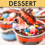 a spoon scooping a bite of dessert from a dirt cup with other cups in the background
