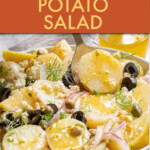 Close up of greek potato salad in a bowl with a spoon