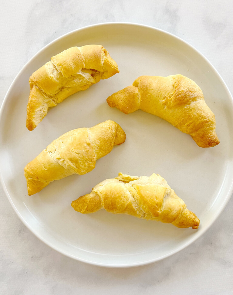 four air fryer crescent rolls on a white plate