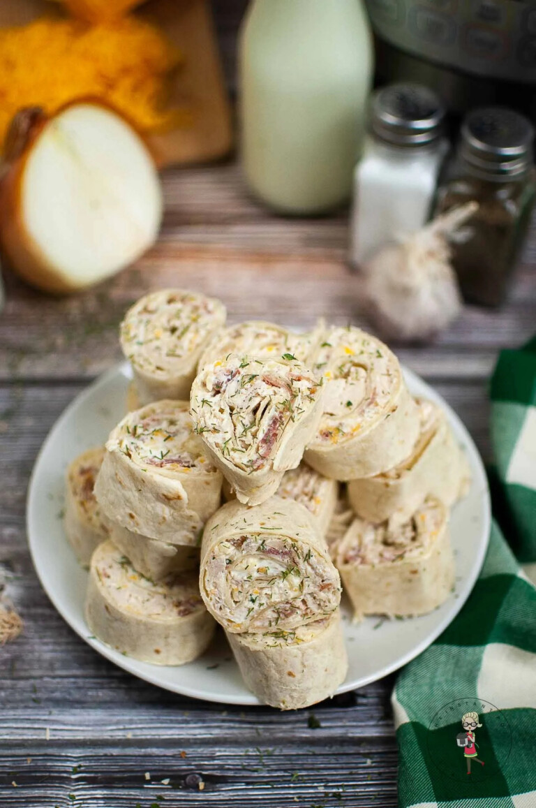 a white plate filled with the finished Instant Pot Crack Chicken Pinwheels