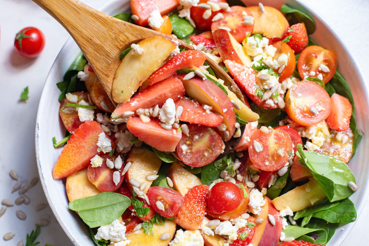 close up view of tomato feta salad with honey mustard dressing