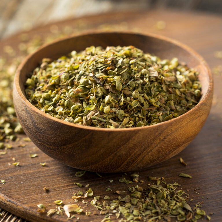 A wooden bowl of dried oregano