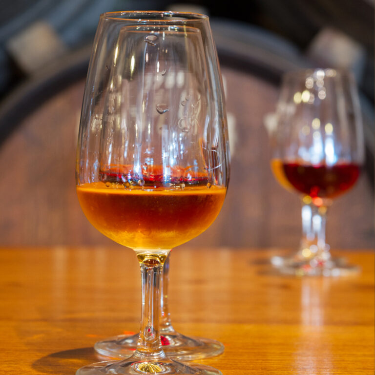 Sherry in a stemmed glass with more glasses in the background