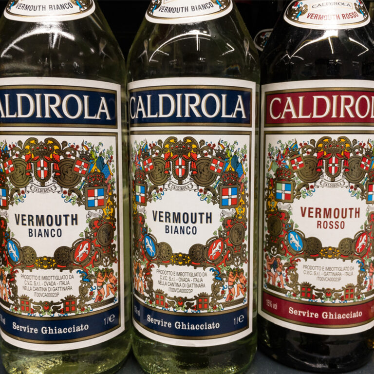 Close up of the labels on three bottles of vermouth