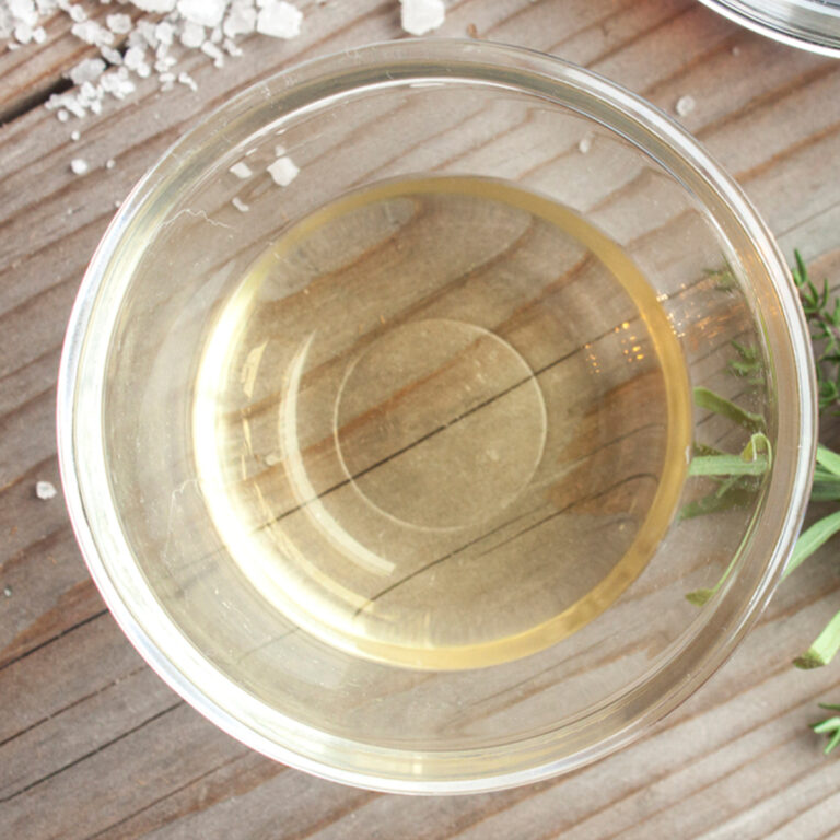 Overhead view of a glass bowl of white wine vinegar