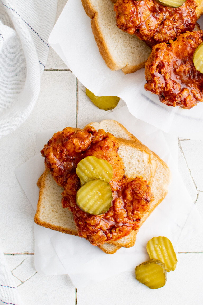 the air fryer nashville hot chicken served on bread and topped with pickle slices