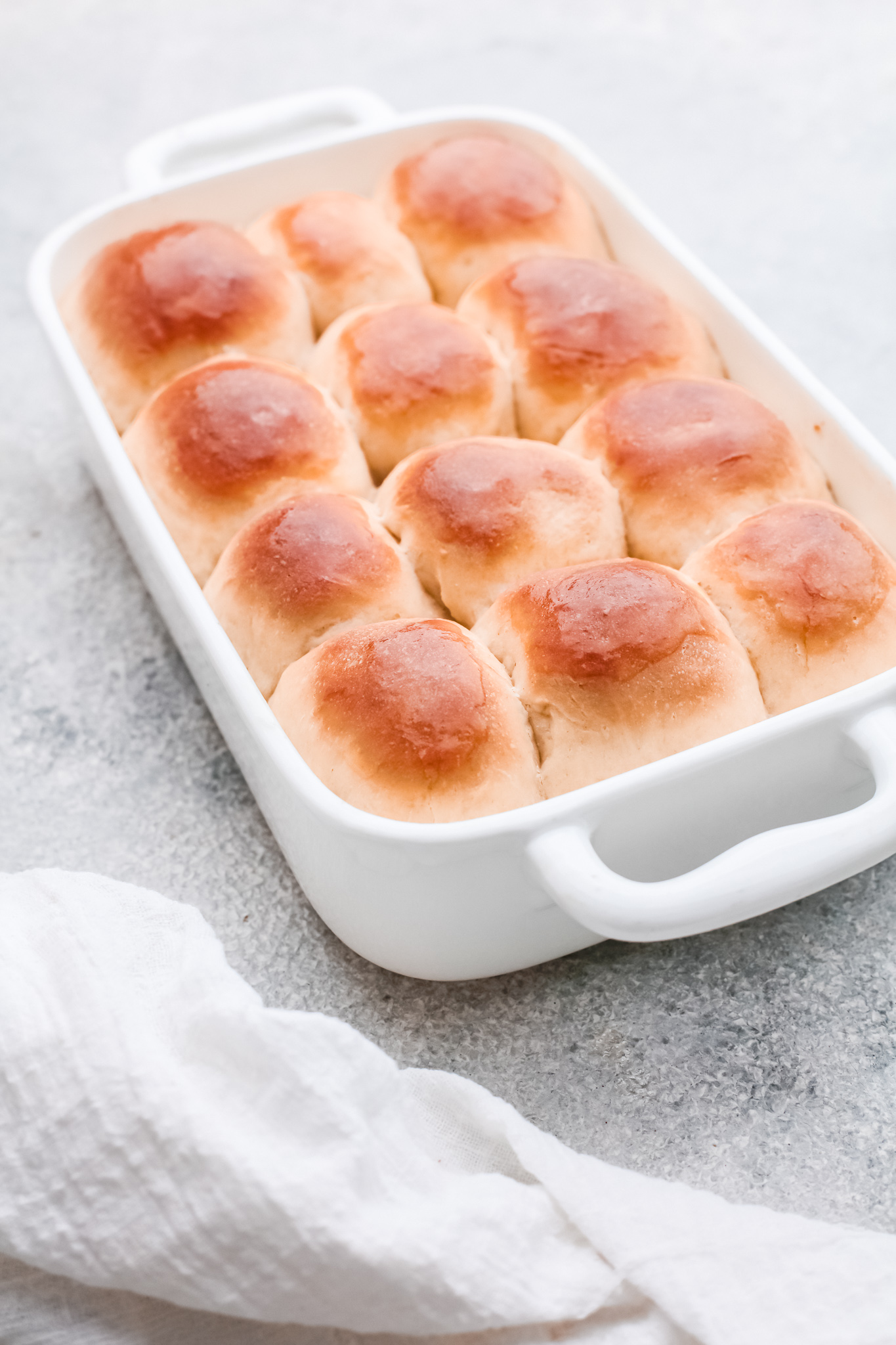 easy yeast rolls in a white baking dish