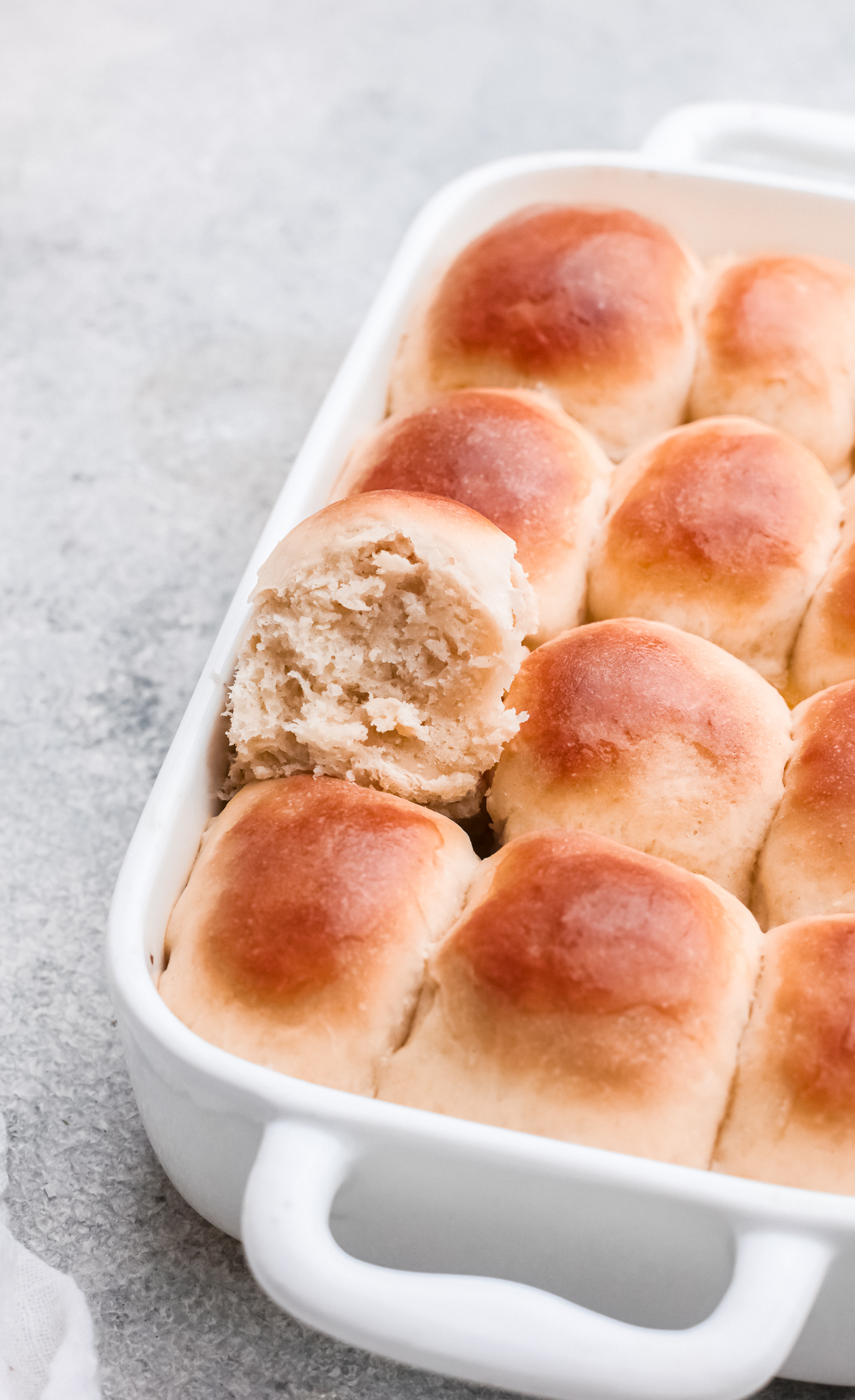 close up of the baked homemade yeast rolls with one roll pulled out