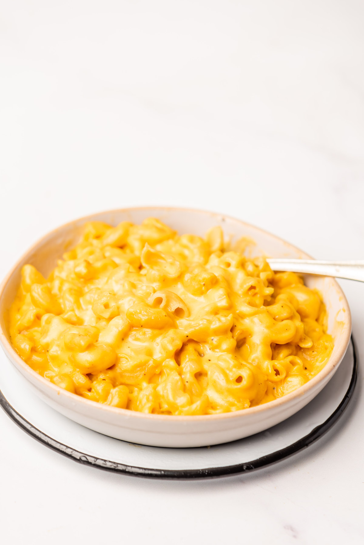 a white bowl filled with gliuten free mac and cheese