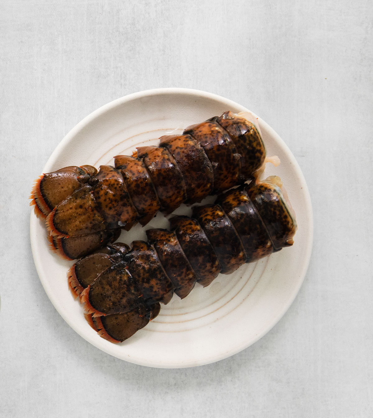 two lobster tails on a plate