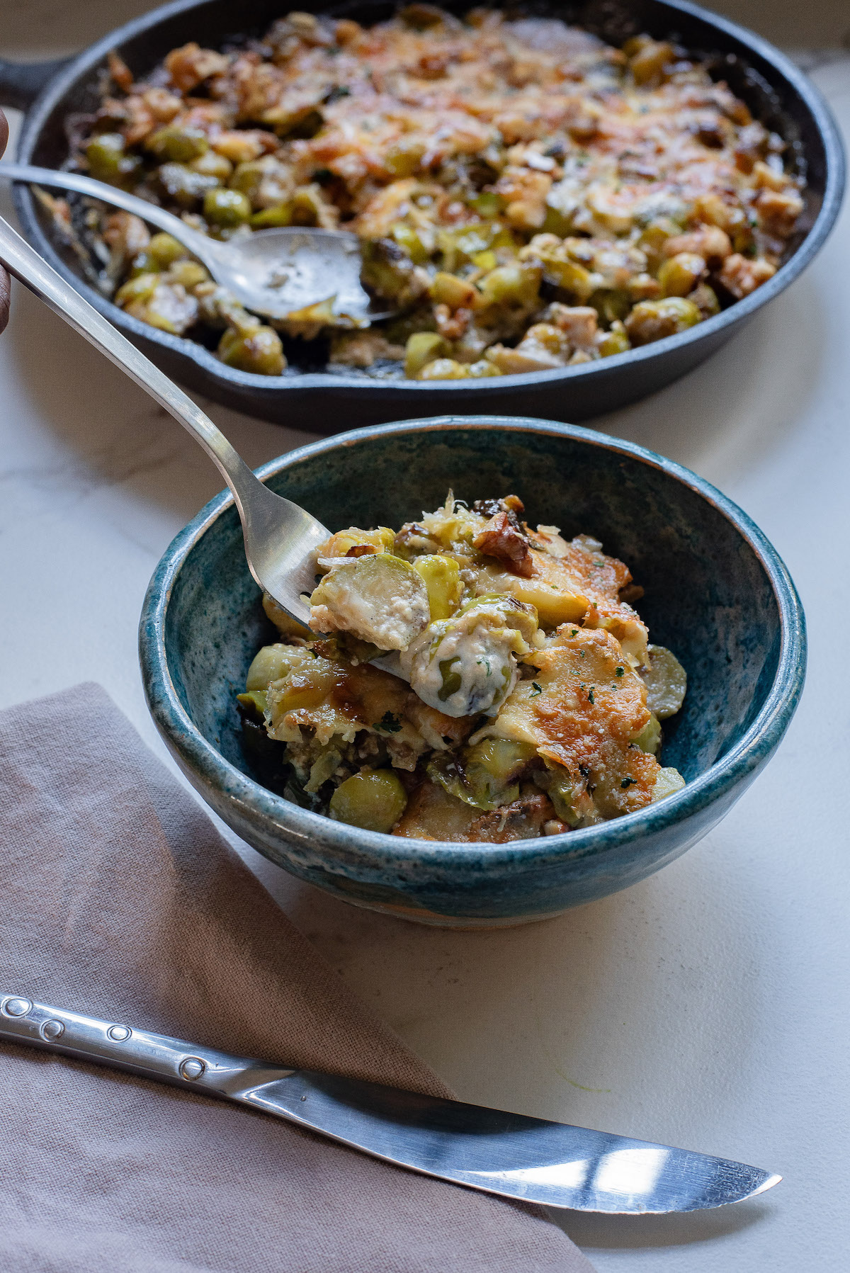 a dish of brussel sprouts gratin with a fork inside