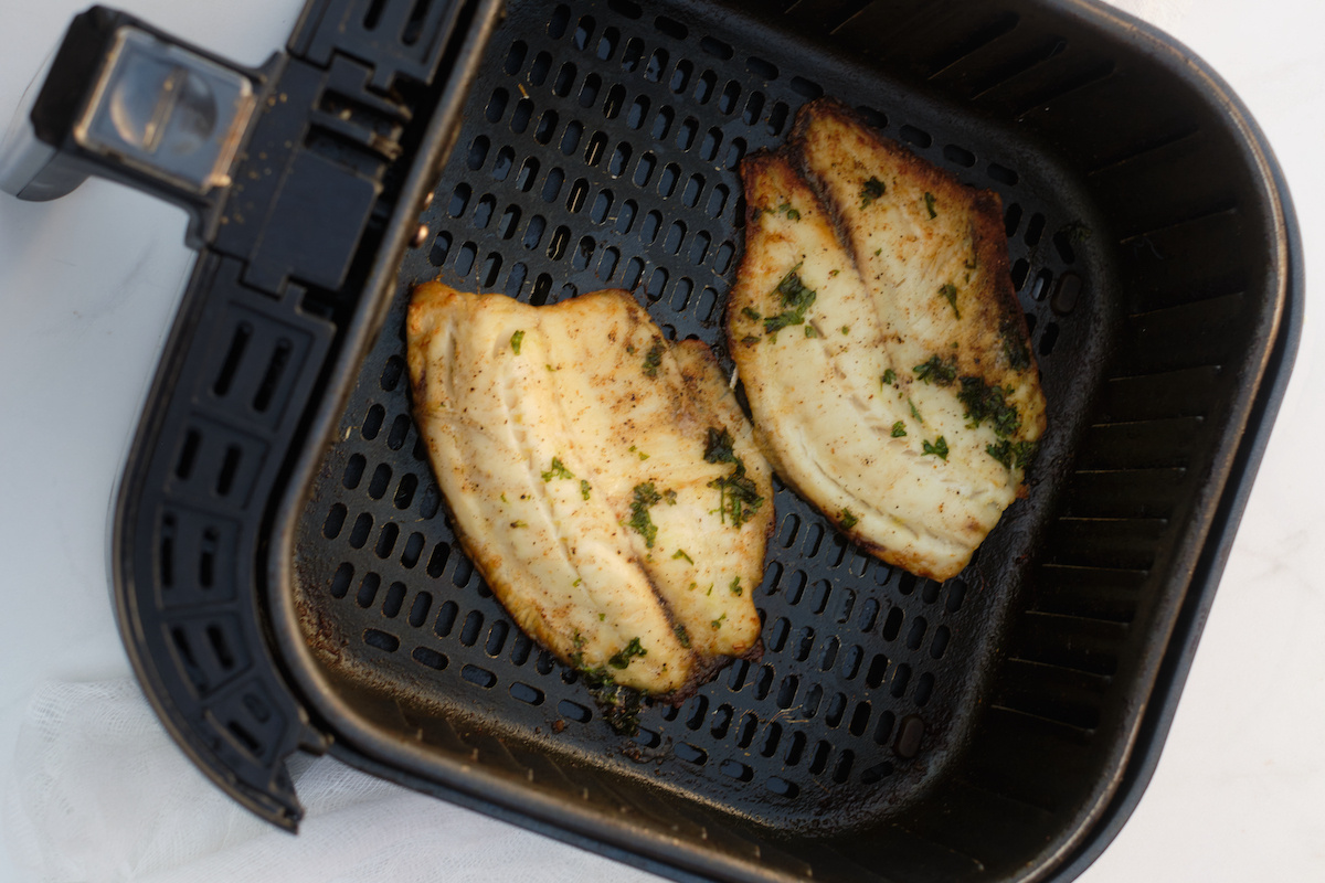 the cooked frozen tilapia air fryer inside the basket
