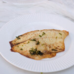 the finished frozen tilapia air fryer recipe served on a white plate