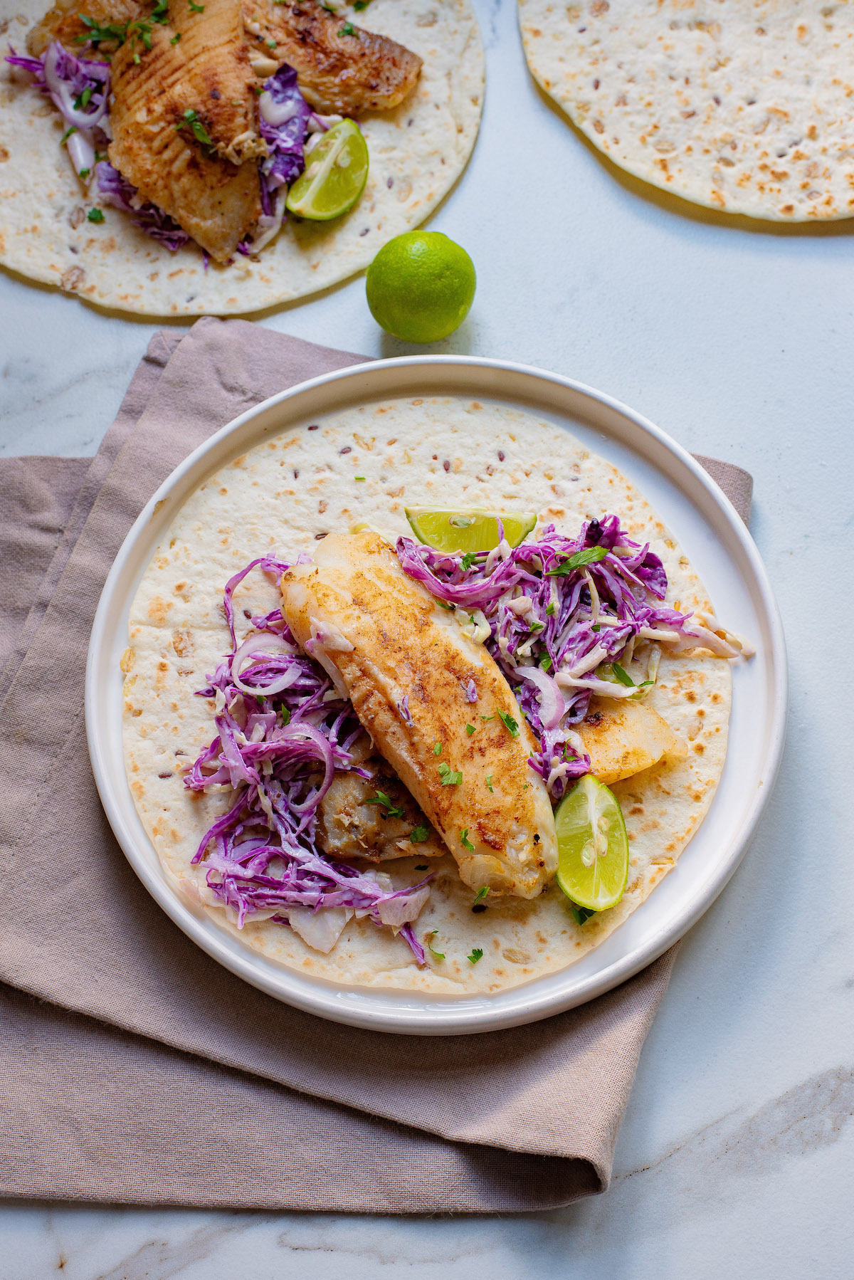 one of the air fryer fish tacos served on a plate