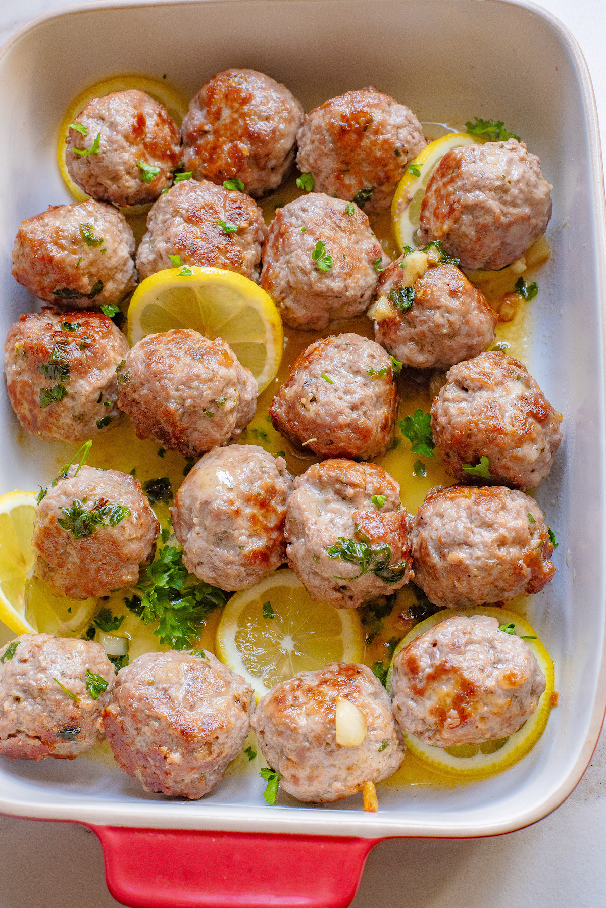 the baked turkey meatballs garnished with lemon and parsley