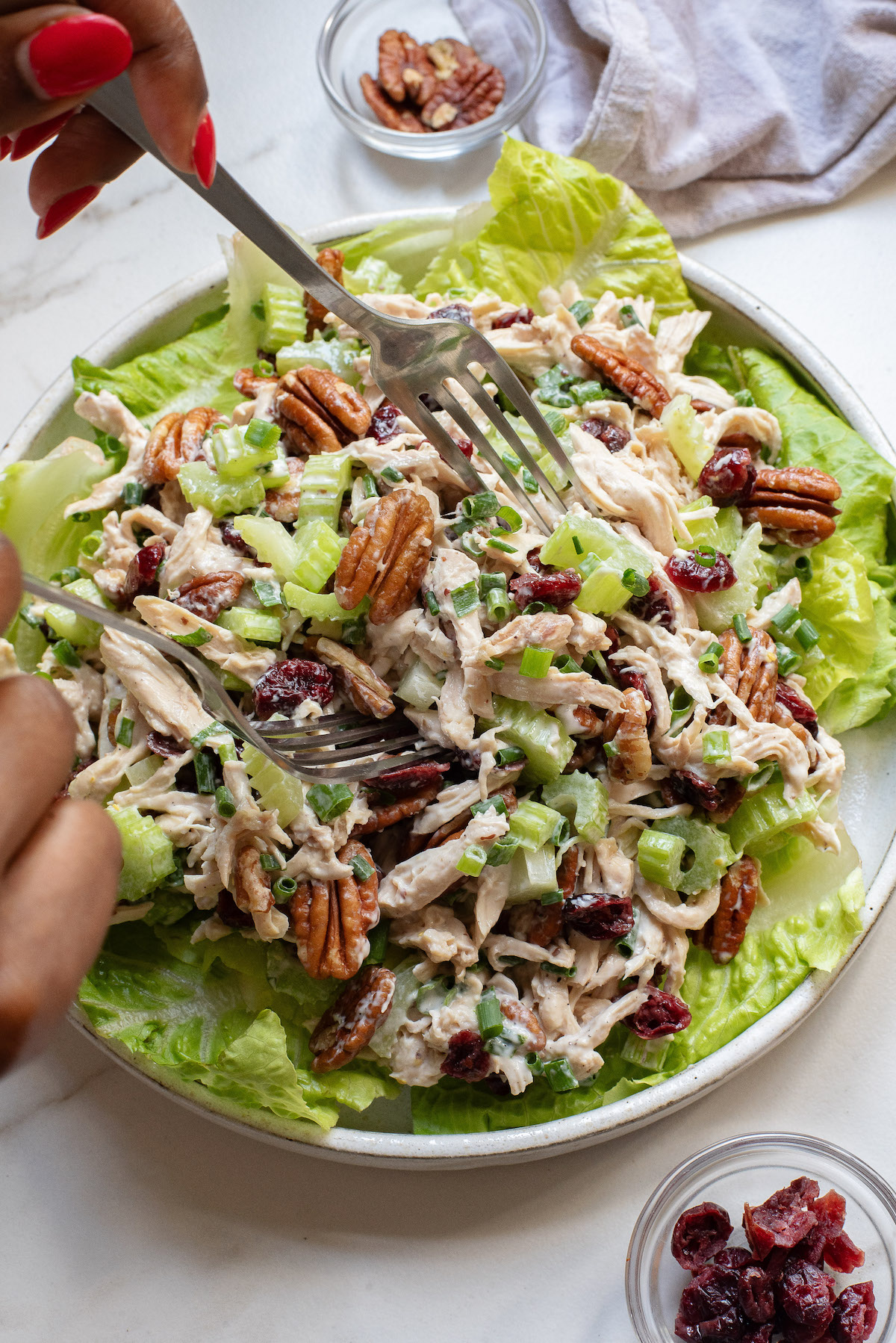 a folk removing a portion of cranberry chicken salad from a plate