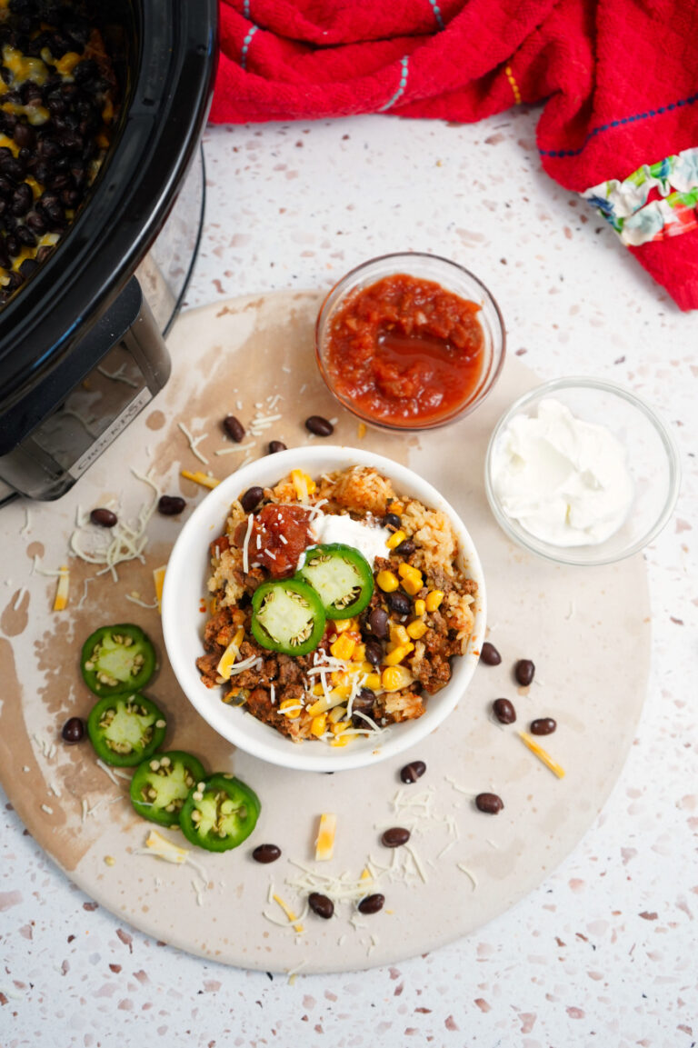 Slow Cooker Ground Beef Taco Bowls with garnish.