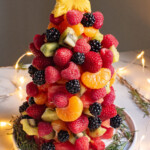 the final assembled fruit christmas tree on a holiday table