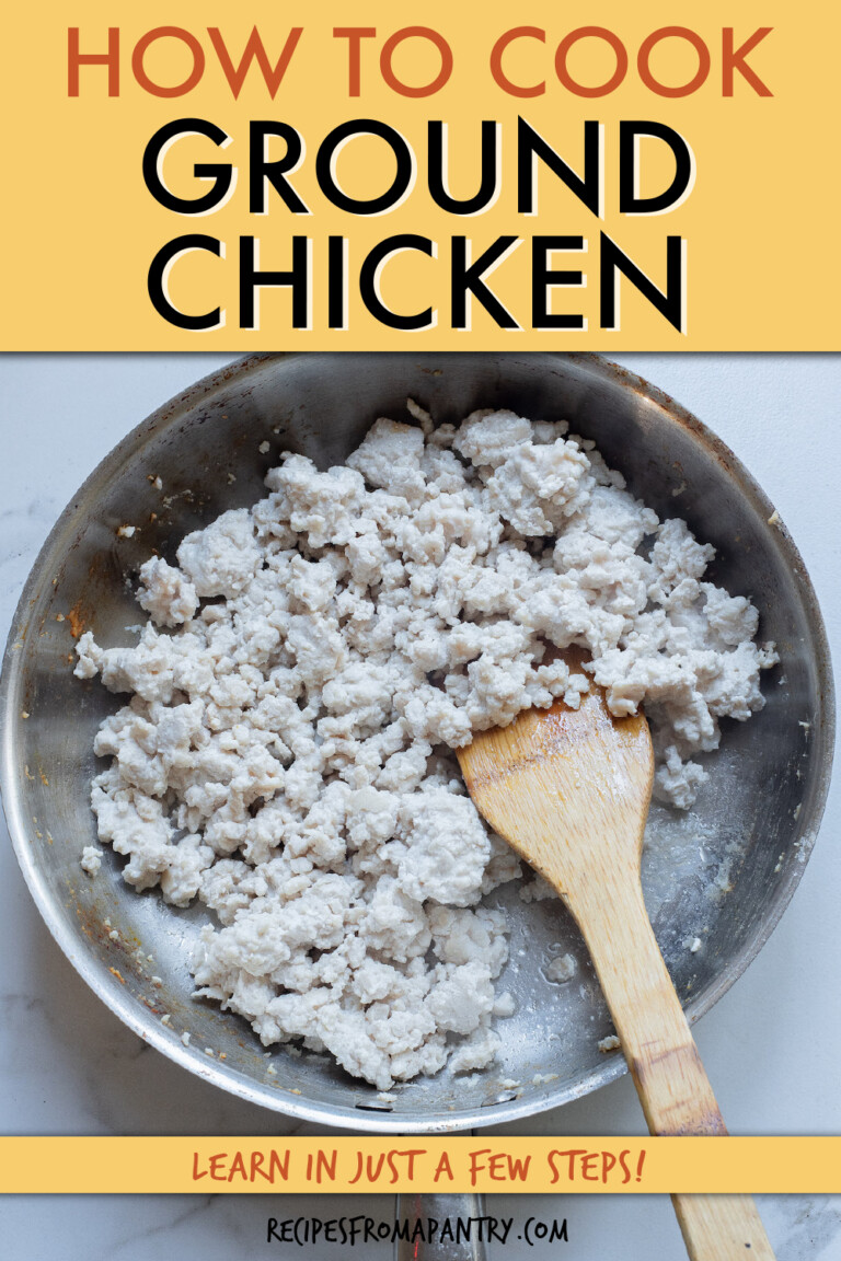 Ground chicken in a pan with a wooden spatula