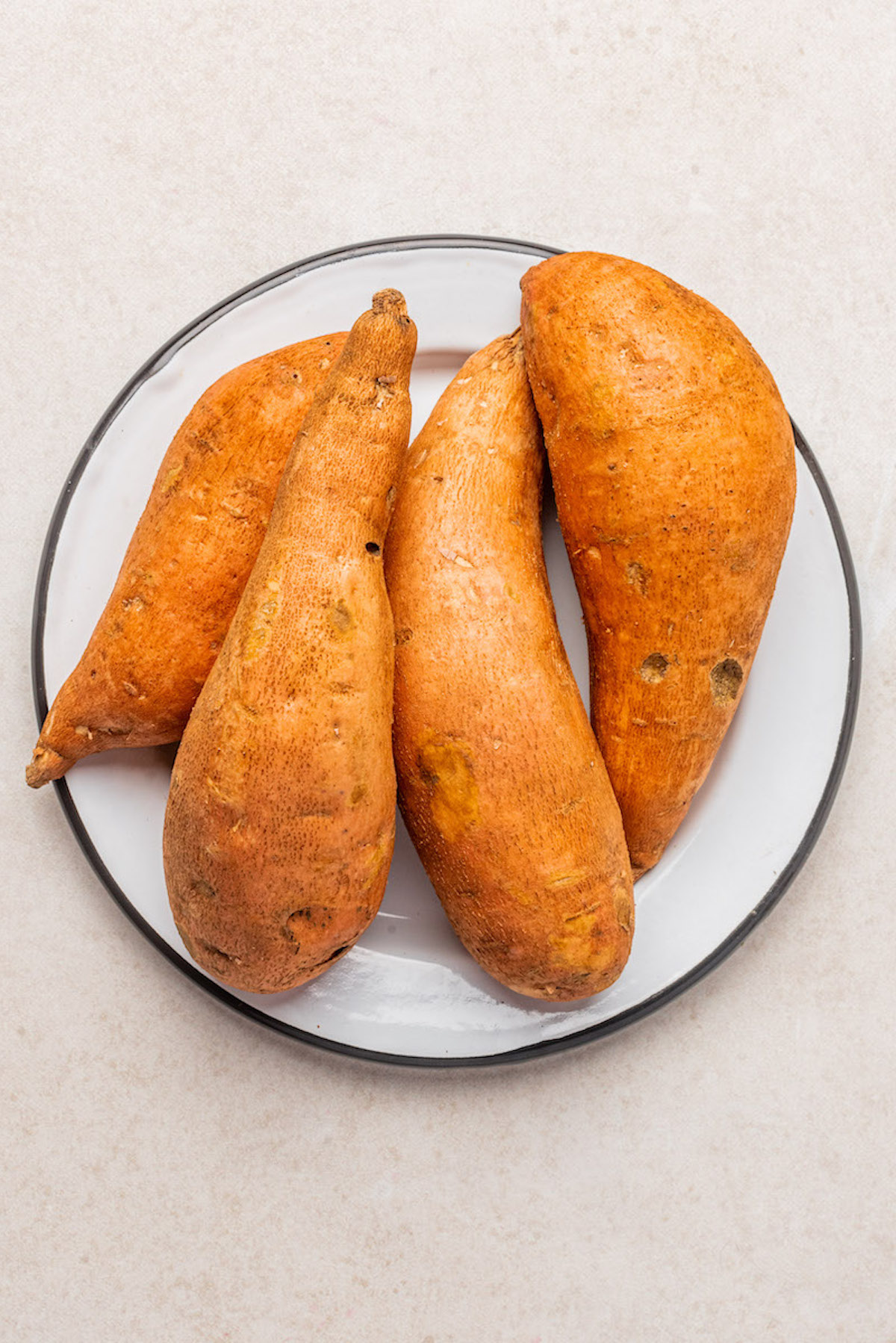 four sweet potatoes on a plate
