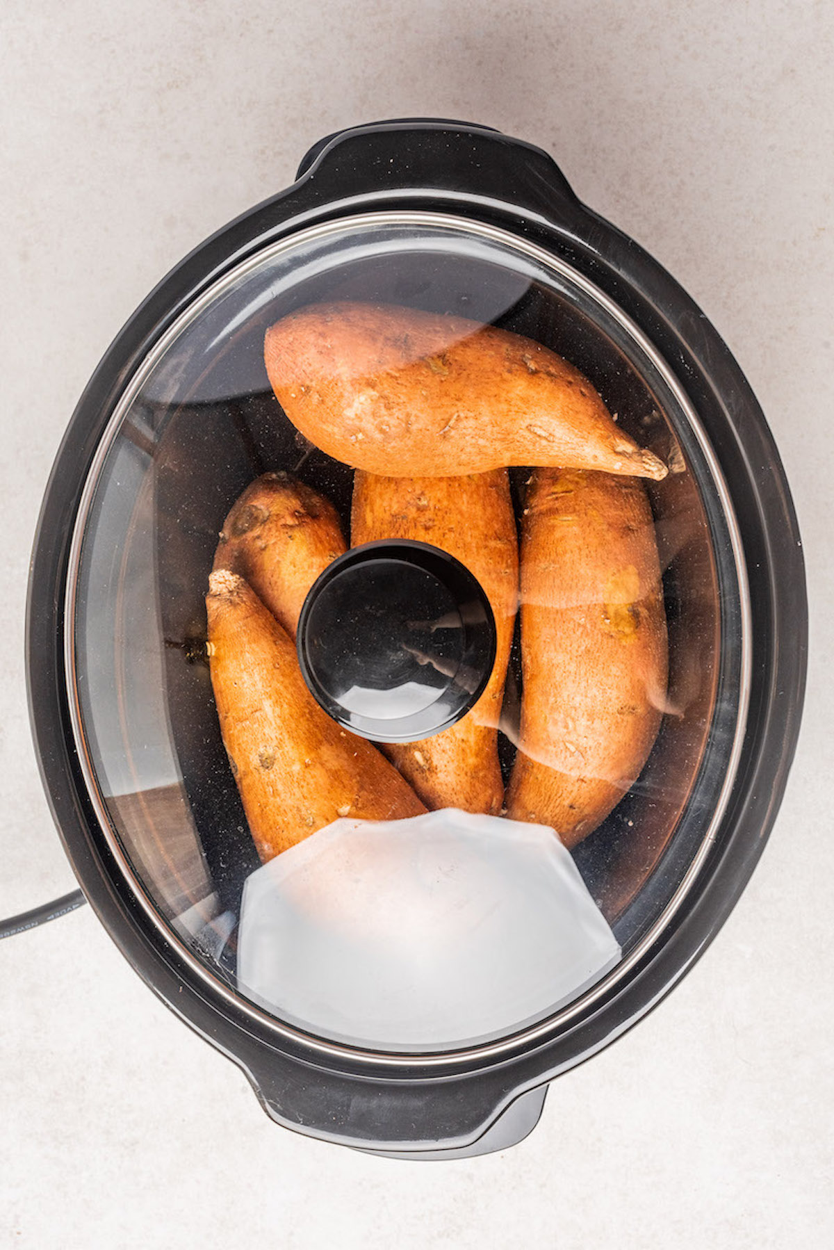 sweet potatoes inside the crockpot with the lid on