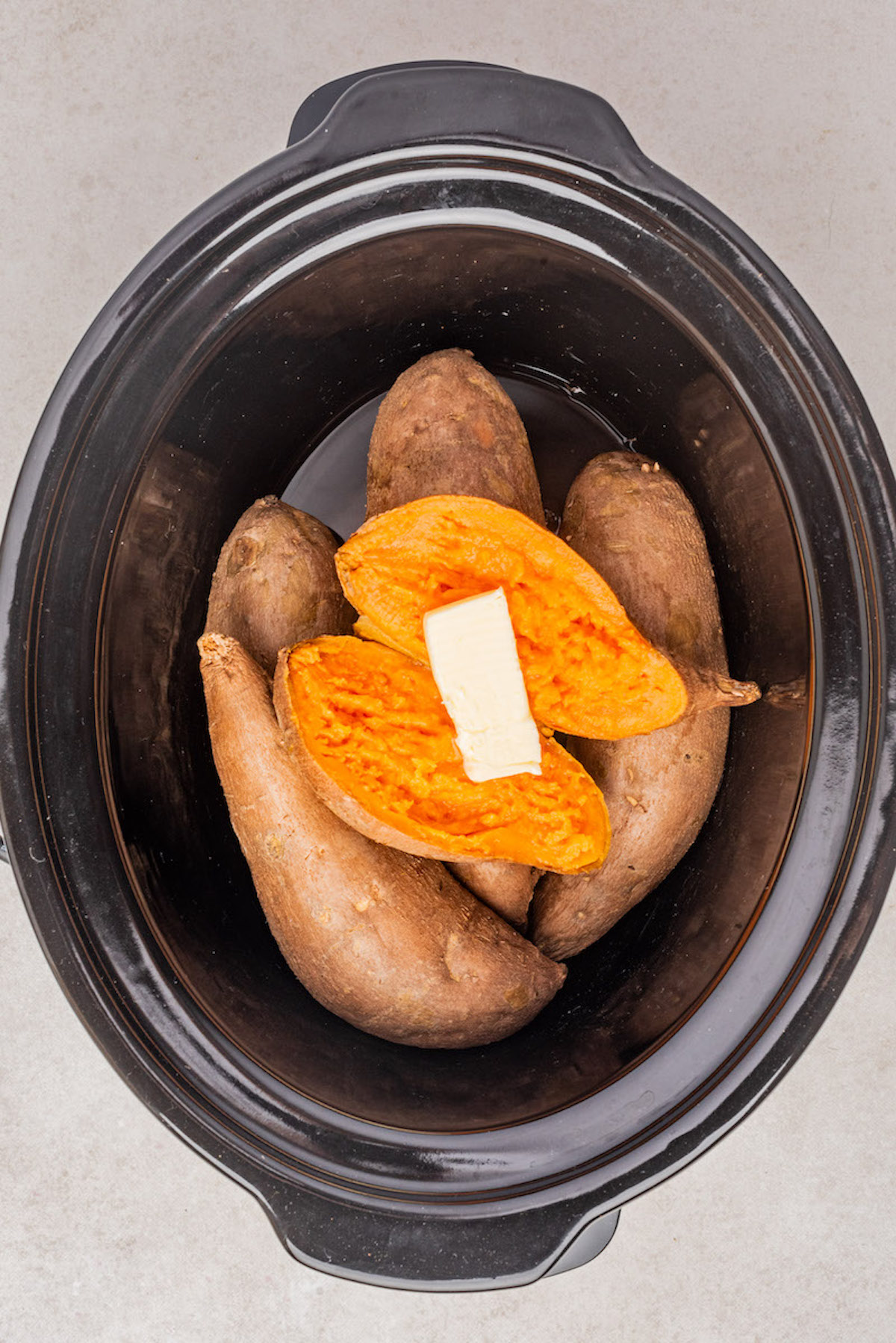 top down view of the cooked sweet potatoes inside the crockpot insert