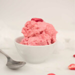 the finished Ninja Creami Strawberry Ice Cream served in a bowl and topped with freeze dried strawberry pieces