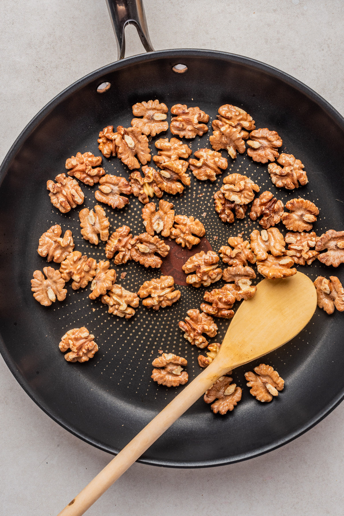 close up of toasted walnuts in a skillet