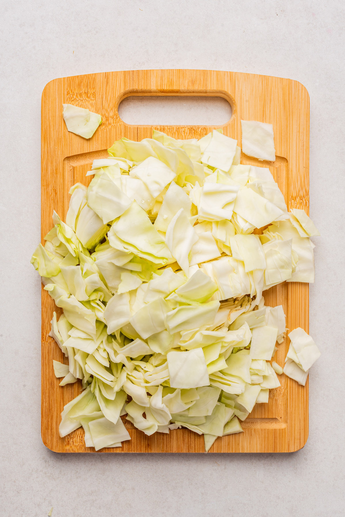 top down view of chopped cabbage on a cutting board