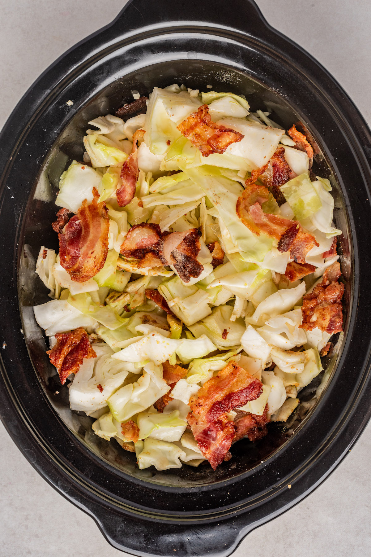 top down view of the recipe ingredients combined in the slow cooker insert