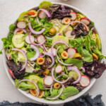 the tossed salad recipe with a pitcher of homemade dressing on the side