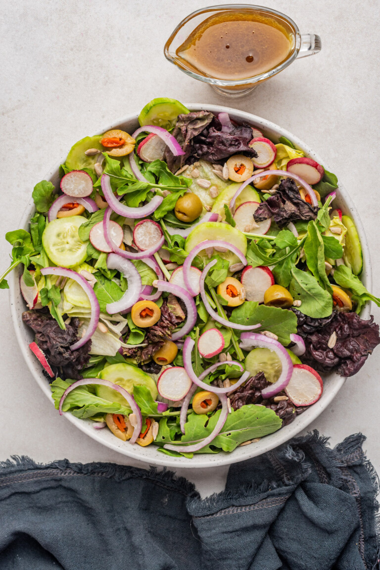the tossed salad recipe with a pitcher of homemade dressing on the side