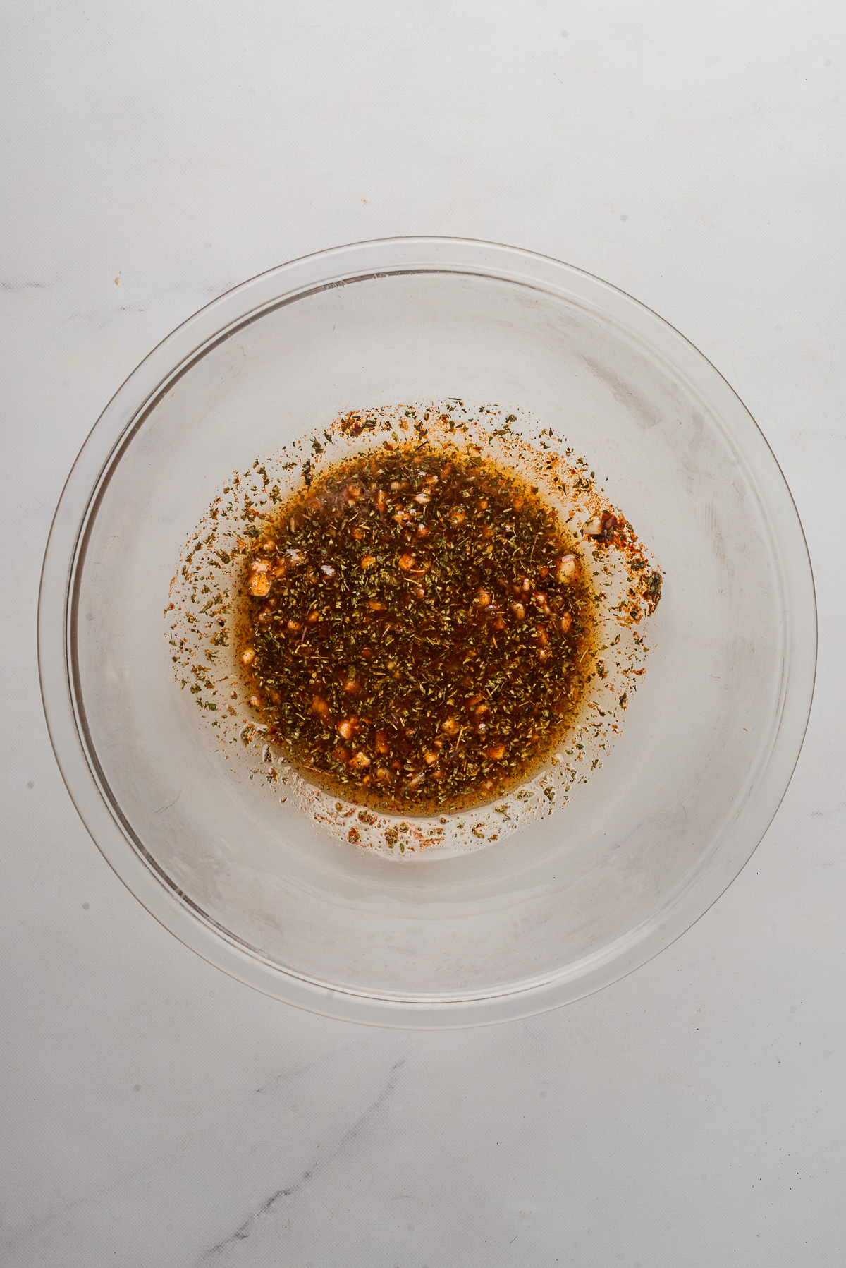 Marinade for chicken souvlaki for chicken in a mixing bowl.