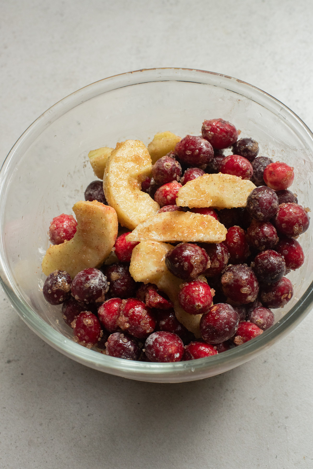 apples and cranberries combined in a large bowl