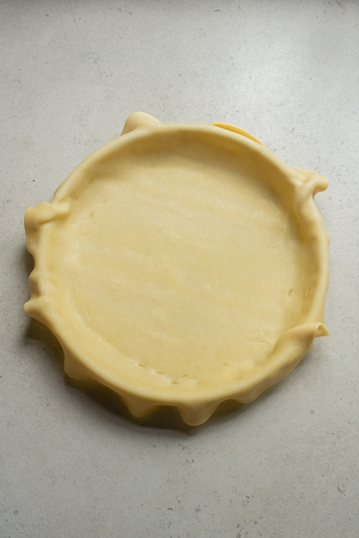 one pie crust placed inside a pie baking dish