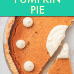 Overhead view of a pumpkin pie with a piece cut out.