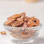 the finished how to toast pecans recipe served in a glass bowl