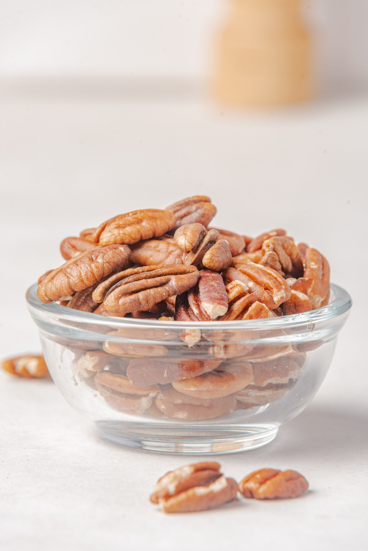 the finished how to toast pecans recipe served in a glass bowl