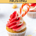 A cupcake with red and white frosting garnished with a candy cane.