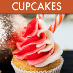 A cupcake with red and white frosting garnished with a candy cane.